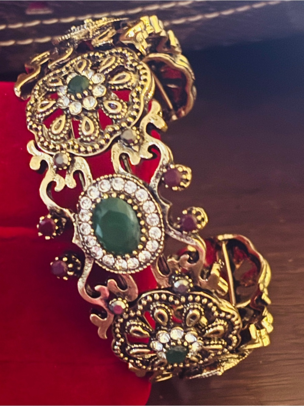 Gold-Tone Filigree Bracelet with Emerald Green Accents
